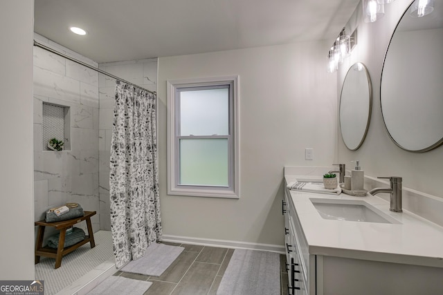 bathroom with a shower with shower curtain and vanity