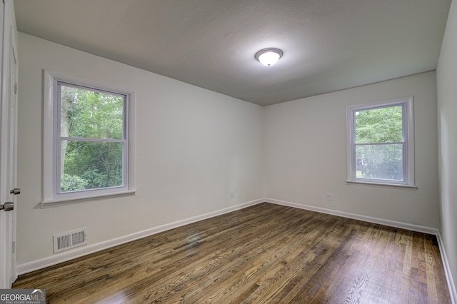 unfurnished room featuring dark wood-type flooring