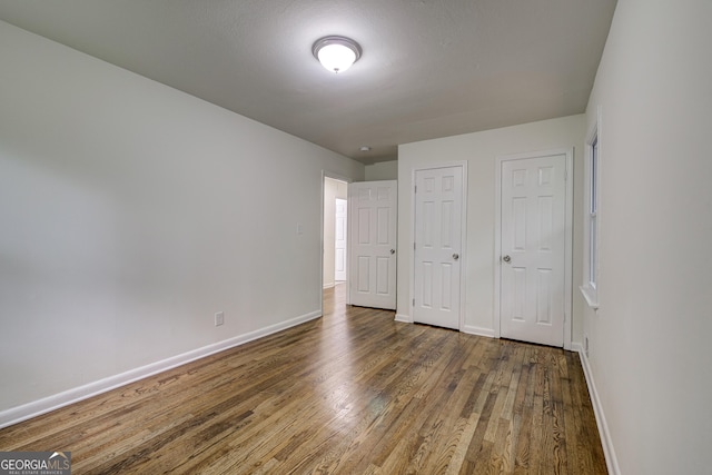 unfurnished bedroom featuring dark wood-type flooring