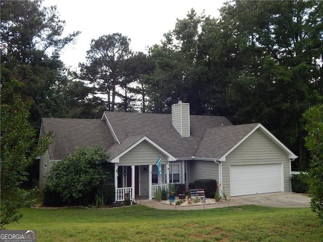 view of front of property featuring a porch, a garage, and a front yard