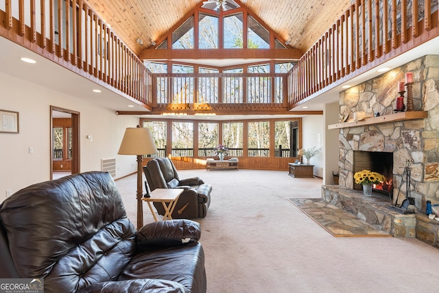 carpeted living room with wooden ceiling, a fireplace, and high vaulted ceiling