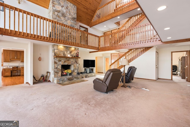 living room featuring a stone fireplace, light colored carpet, high vaulted ceiling, and built in desk