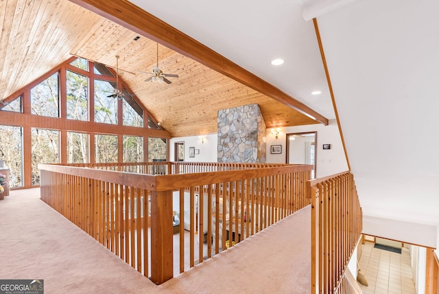 hallway with carpet flooring, beamed ceiling, wood ceiling, and high vaulted ceiling