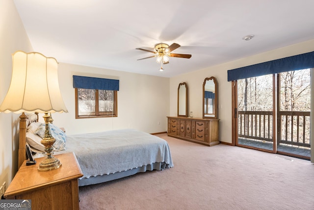 carpeted bedroom with ceiling fan and access to exterior