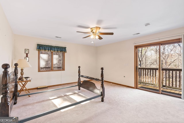 carpeted bedroom featuring ceiling fan and access to exterior