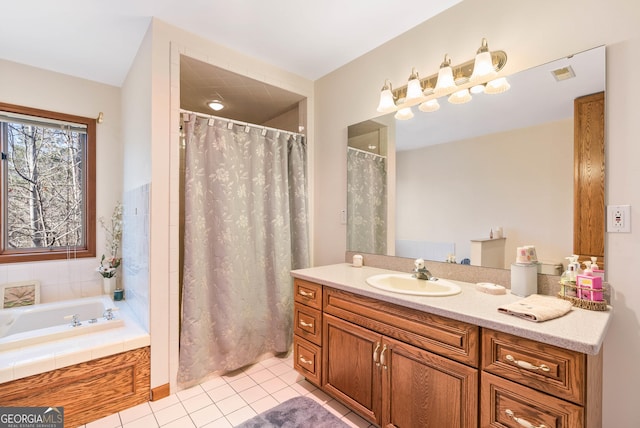 bathroom featuring tile patterned flooring, vanity, and independent shower and bath