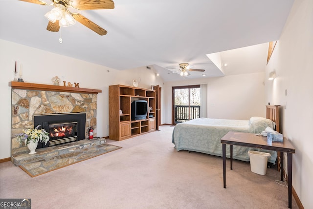 bedroom featuring ceiling fan, a fireplace, light colored carpet, and lofted ceiling