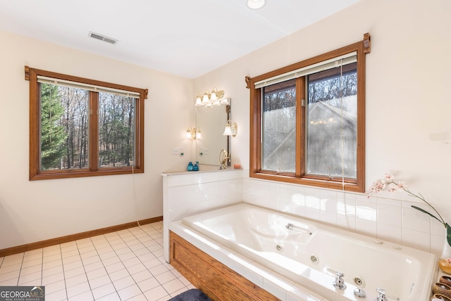 bathroom featuring tile patterned floors and tiled tub