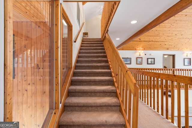 stairs with carpet and a high ceiling