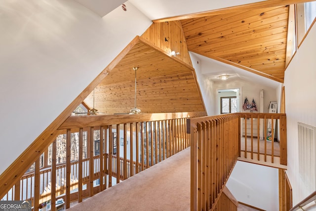 hall with carpet flooring and high vaulted ceiling