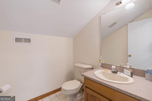 bathroom with tile patterned flooring, vanity, toilet, and lofted ceiling