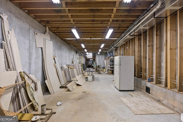 basement with white refrigerator