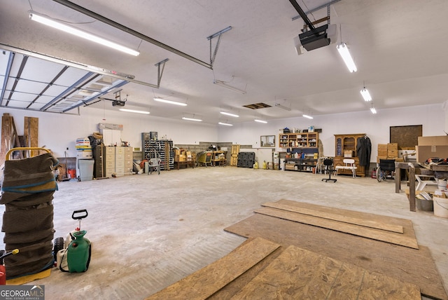 garage featuring a workshop area and a garage door opener