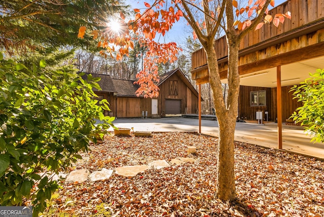 view of yard featuring a garage and an outdoor structure