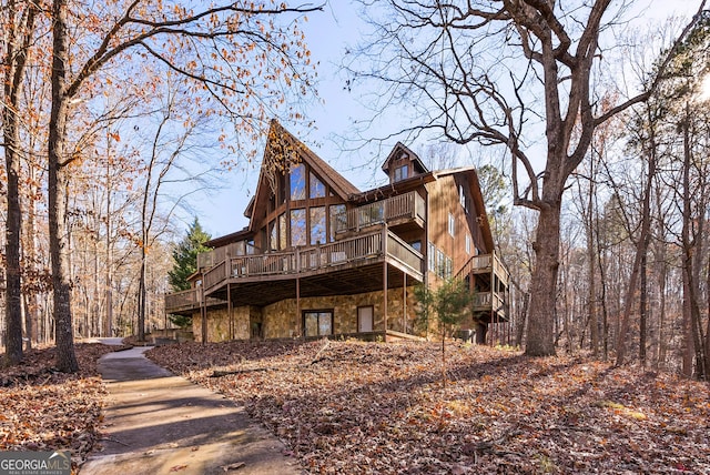 rear view of house featuring a deck