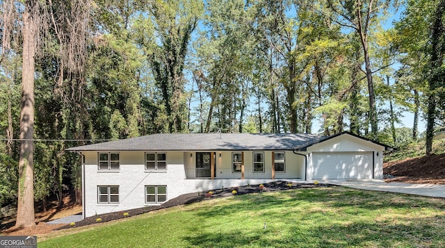 single story home featuring covered porch, a garage, and a front yard