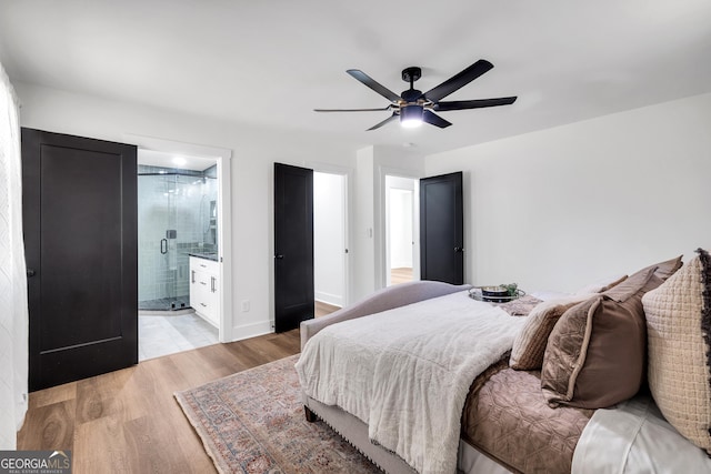 bedroom with light wood-type flooring, connected bathroom, and ceiling fan