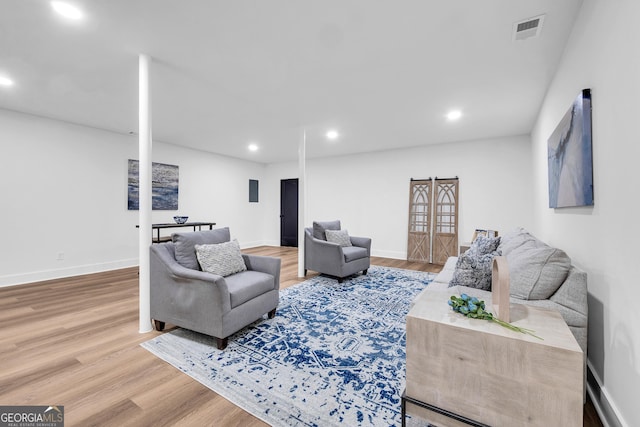 living room with hardwood / wood-style floors and french doors