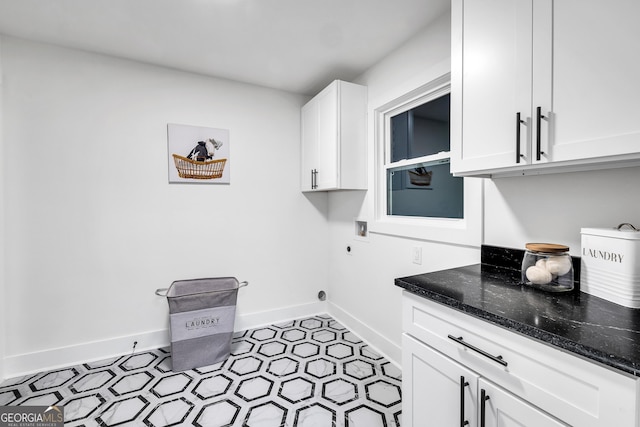 laundry room featuring hookup for an electric dryer and cabinets