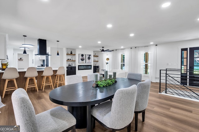 dining space with hardwood / wood-style flooring and ceiling fan