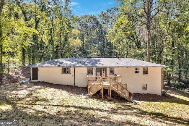 rear view of property featuring a deck