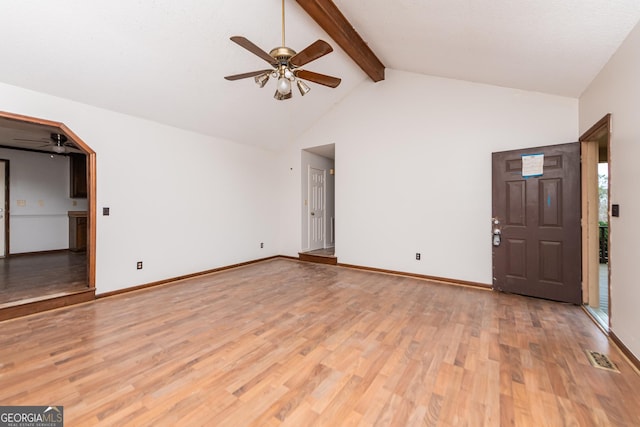 unfurnished living room with ceiling fan, beam ceiling, high vaulted ceiling, and light hardwood / wood-style flooring