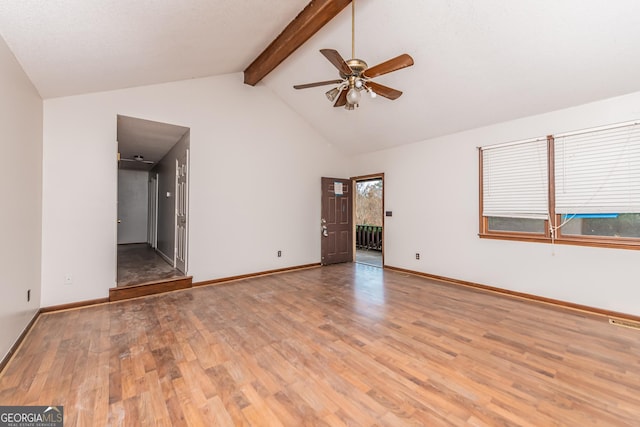 spare room with vaulted ceiling with beams, light hardwood / wood-style floors, and ceiling fan