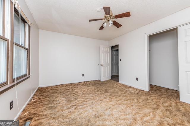 unfurnished bedroom featuring carpet floors, a closet, multiple windows, and ceiling fan