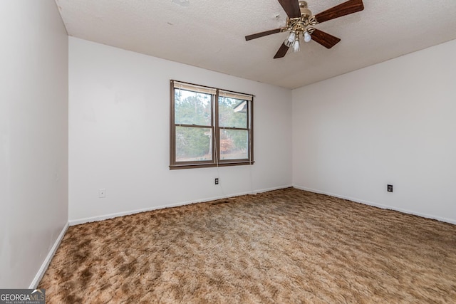 carpeted empty room with ceiling fan and a textured ceiling