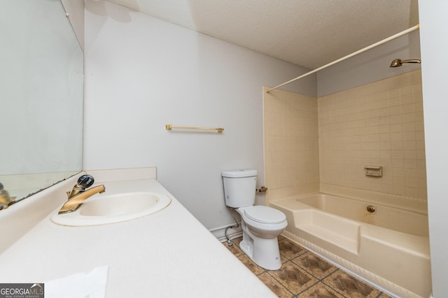 full bathroom with tile patterned floors, a textured ceiling, tiled shower / bath combo, sink, and toilet