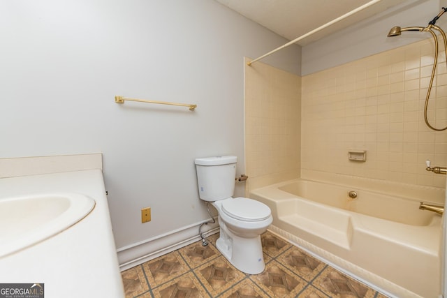 bathroom featuring toilet and tiled shower / bath