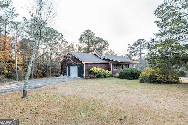 view of home's exterior featuring a garage and a yard