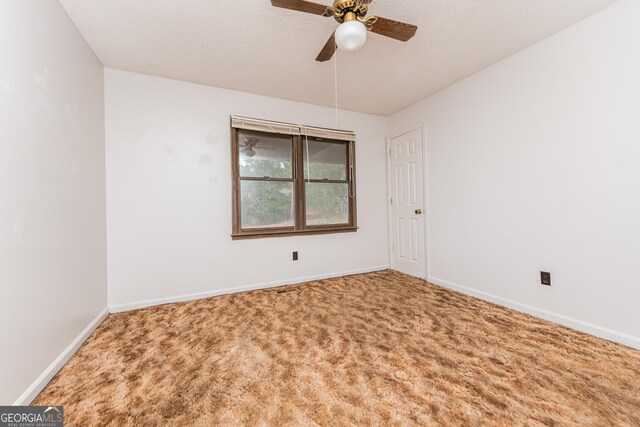 unfurnished room with a textured ceiling, carpet floors, and ceiling fan