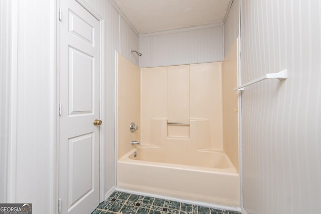 bathroom with shower / bathing tub combination and a textured ceiling