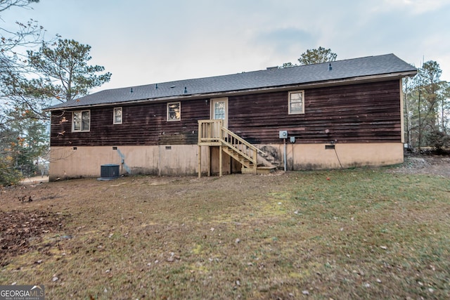 rear view of house featuring a yard and central AC