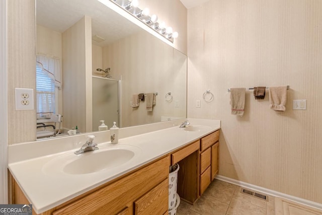 bathroom featuring vanity, tile patterned floors, and walk in shower