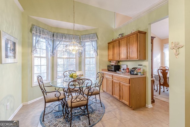 dining room with a wealth of natural light, light tile patterned floors, and a notable chandelier