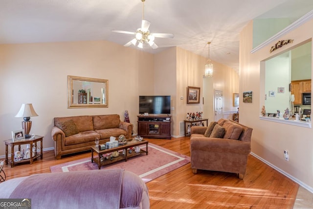 living room with hardwood / wood-style floors, ceiling fan with notable chandelier, and lofted ceiling