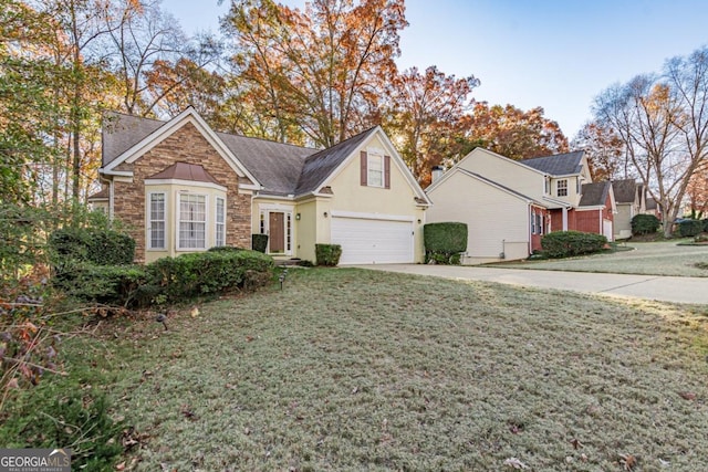 front of property with a garage and a front lawn