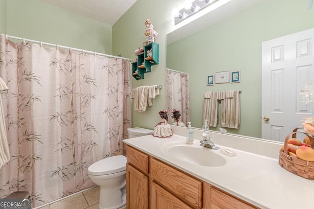 bathroom with tile patterned flooring, vanity, a textured ceiling, and toilet