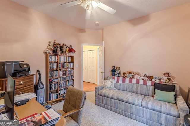 office with carpet flooring, ceiling fan, and a textured ceiling