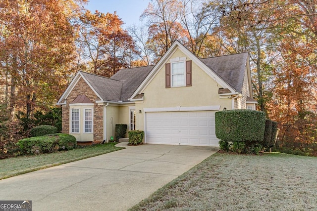 view of property featuring a garage and a front yard