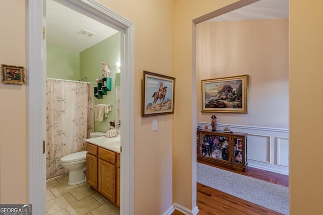 bathroom with tile patterned floors, vanity, and toilet