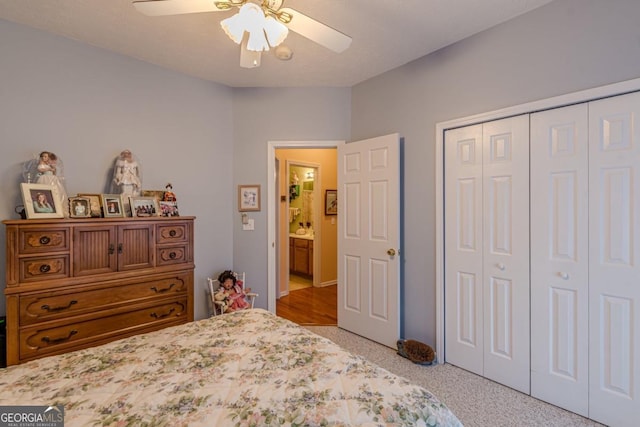 bedroom with ceiling fan, light colored carpet, and a closet