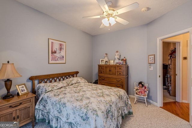 bedroom featuring ceiling fan and light colored carpet