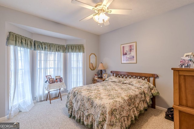 bedroom featuring ceiling fan and light carpet