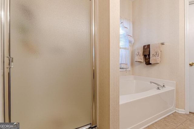 bathroom with tile patterned floors and shower with separate bathtub