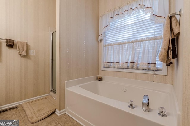 bathroom with tile patterned flooring and plus walk in shower