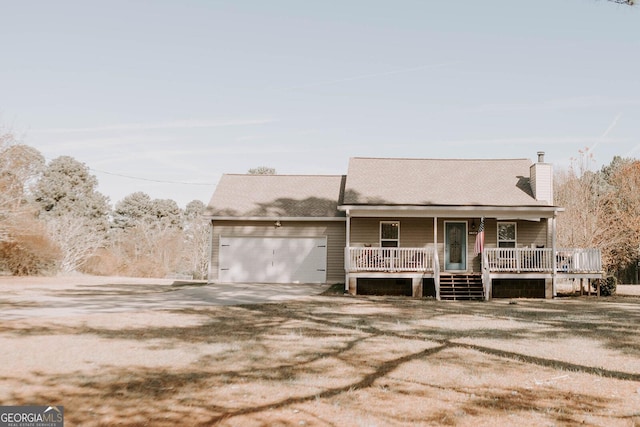 view of front facade featuring a porch and a garage