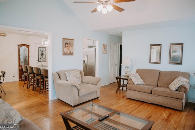 living room featuring ceiling fan, high vaulted ceiling, and wood-type flooring